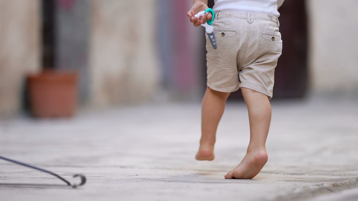 child walking on tiptoes